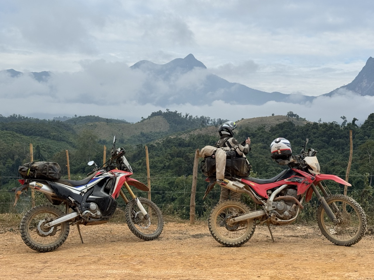 Motorcycles parked at a mountain overlook above the Nam Ou river valley