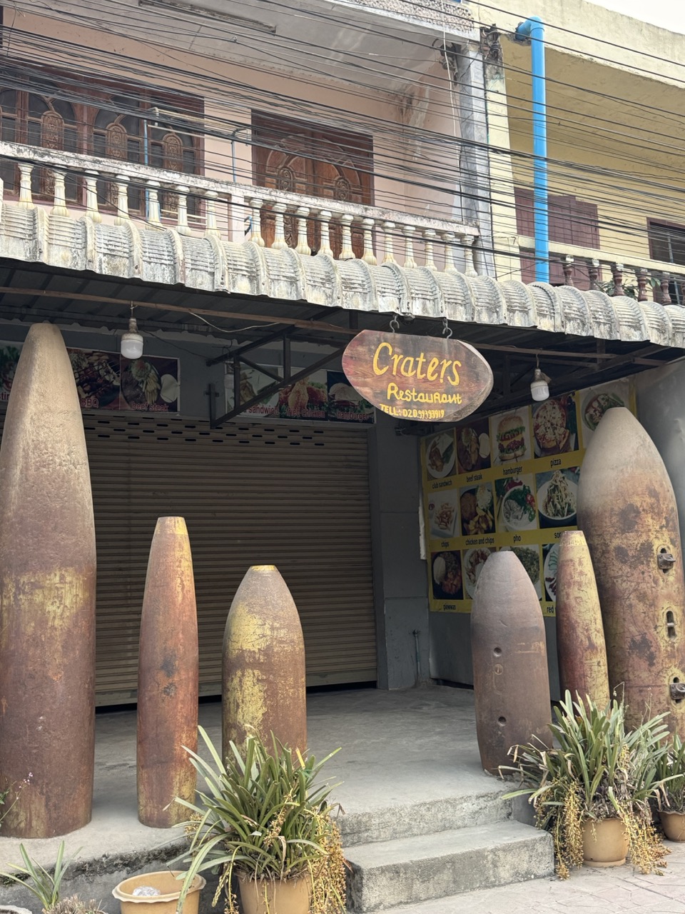 Defused bomb casings displayed inside Crater Restaurant in Phonsavan